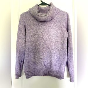 Purple loose turtleneck sweater .